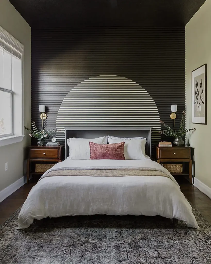 Guest bedroom with black accent wall, geometric design, and simple décor.