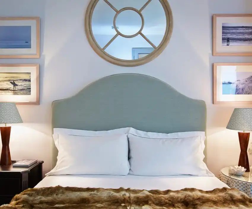 leaf stencil wall, wood headboard, and striped pillows.
