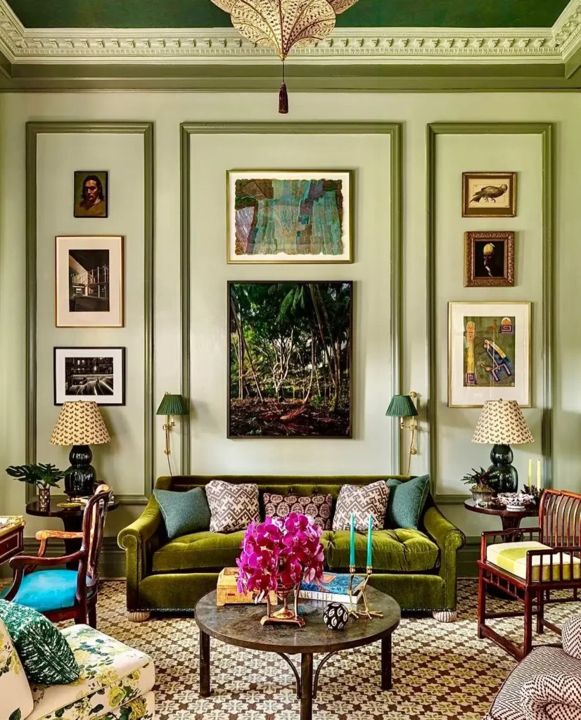 Sophisticated living room with green velvet sofa, ornate moldings, and framed artwork for grand wall decor ideas above couch.