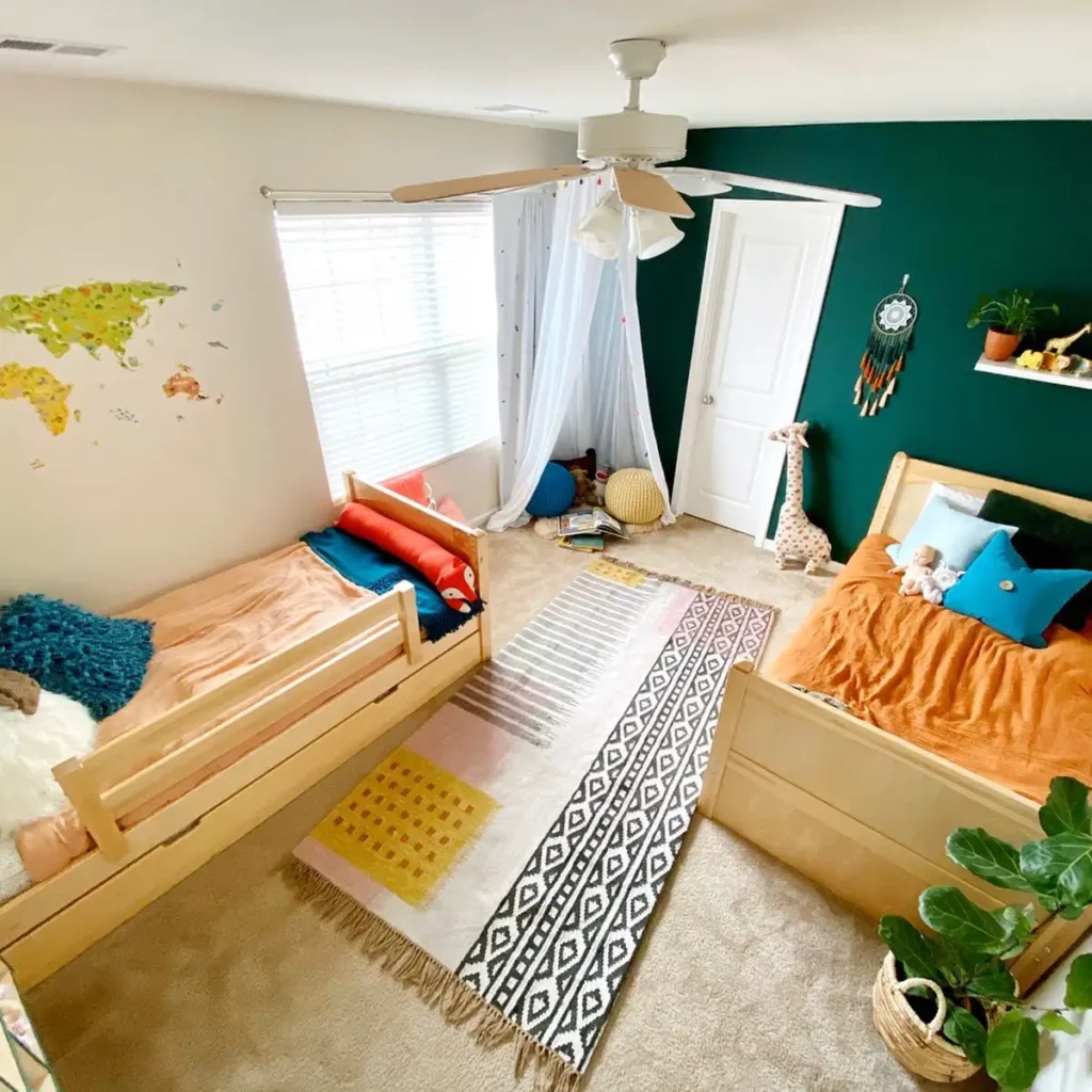 Boy and girl shared bedroom with bold green accent wall, playful bedding, and safari-inspired décor.