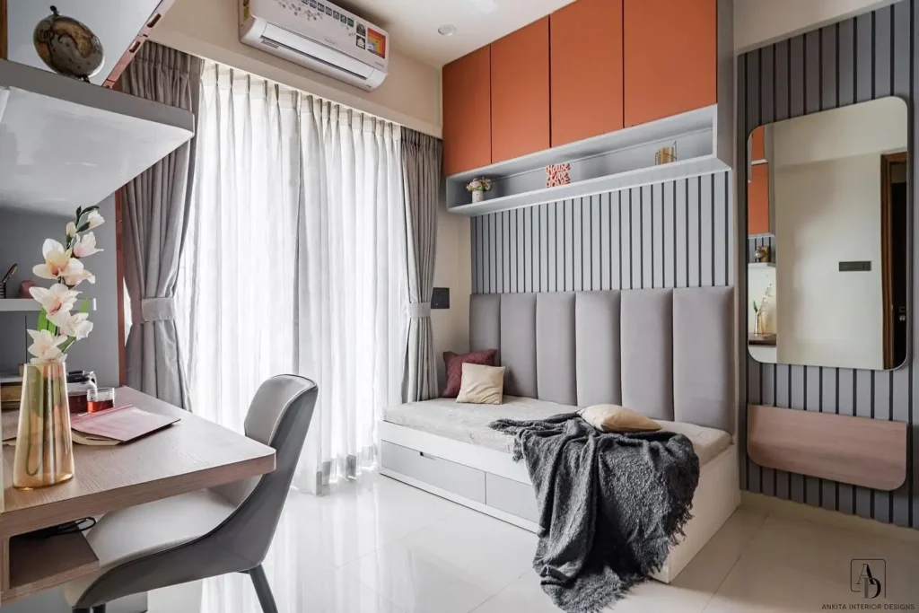 Guest bedroom office with wall-mounted storage, daybed, and wood accents.