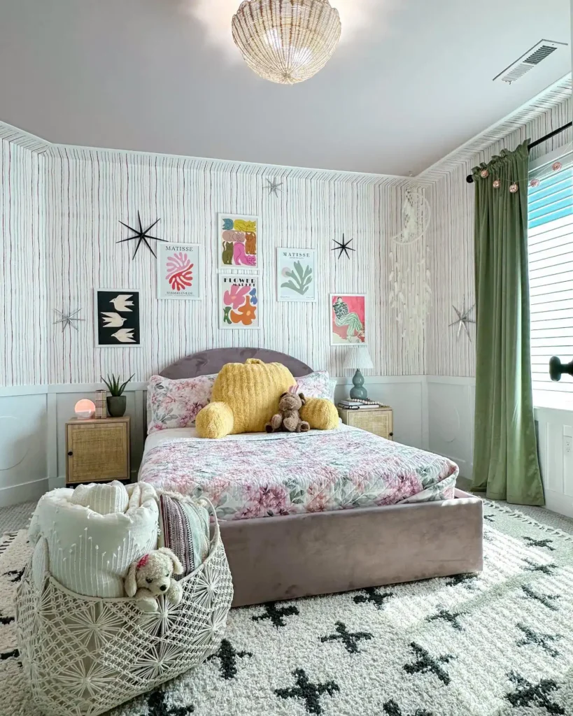 Preteen girls bedroom with star wall decals, floral bedding, green curtains, and bold art prints.
