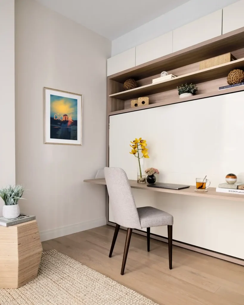 Guest bedroom office combo with hidden Murphy bed and fold-down desk workspace.