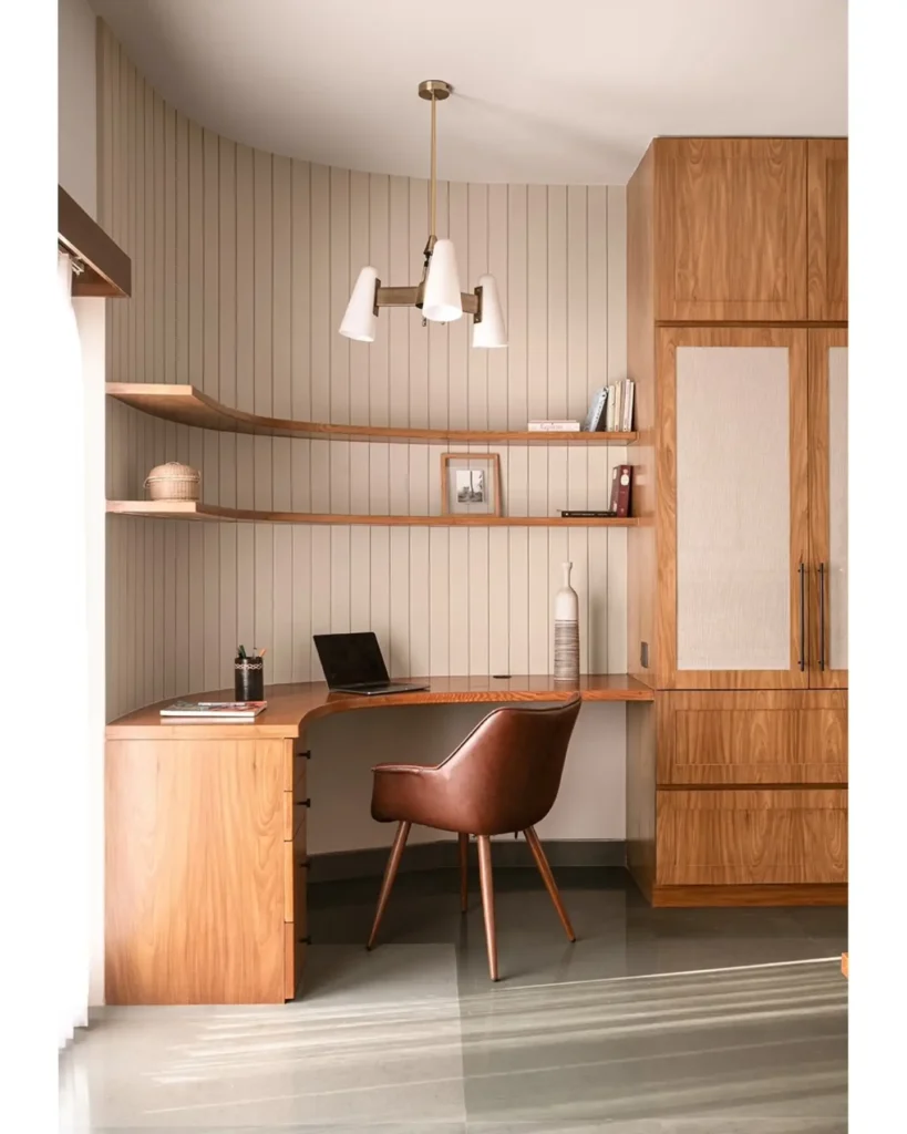 featuring warm wood desk, curved shelving, and leather chair.