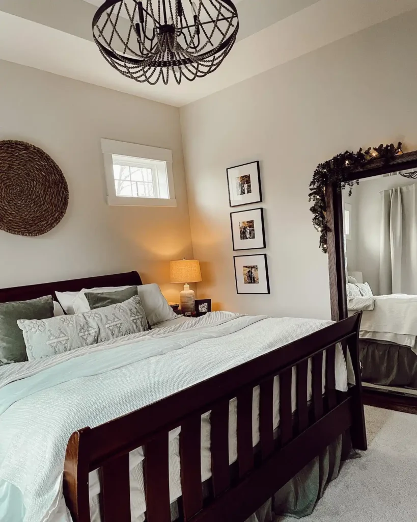 Basement bedroom with arched mirrors, glass lamps, and black headboard.