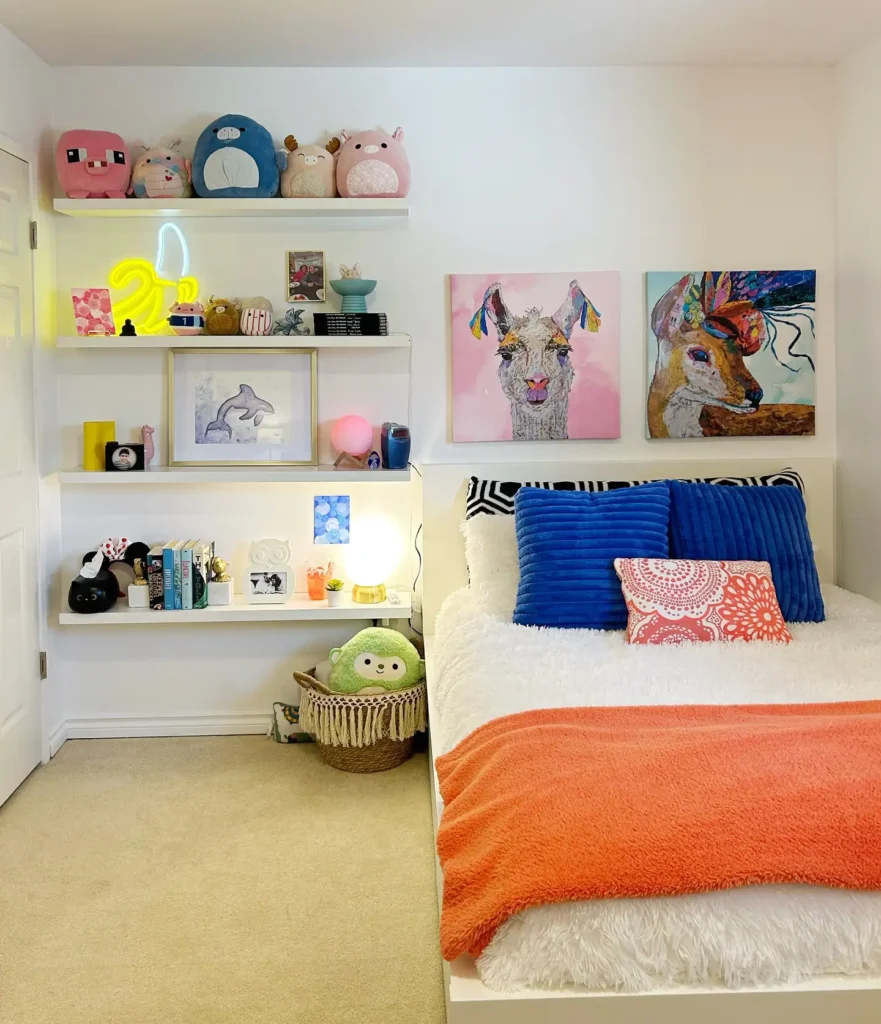 Preteen girls bedroom with colorful wall art, plush toys, neon light, and bold bedding accents.
