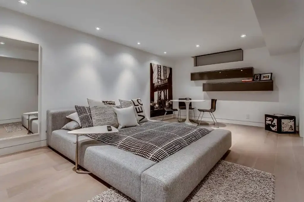 gray platform bed, sleek shelving, and minimalist décor.
