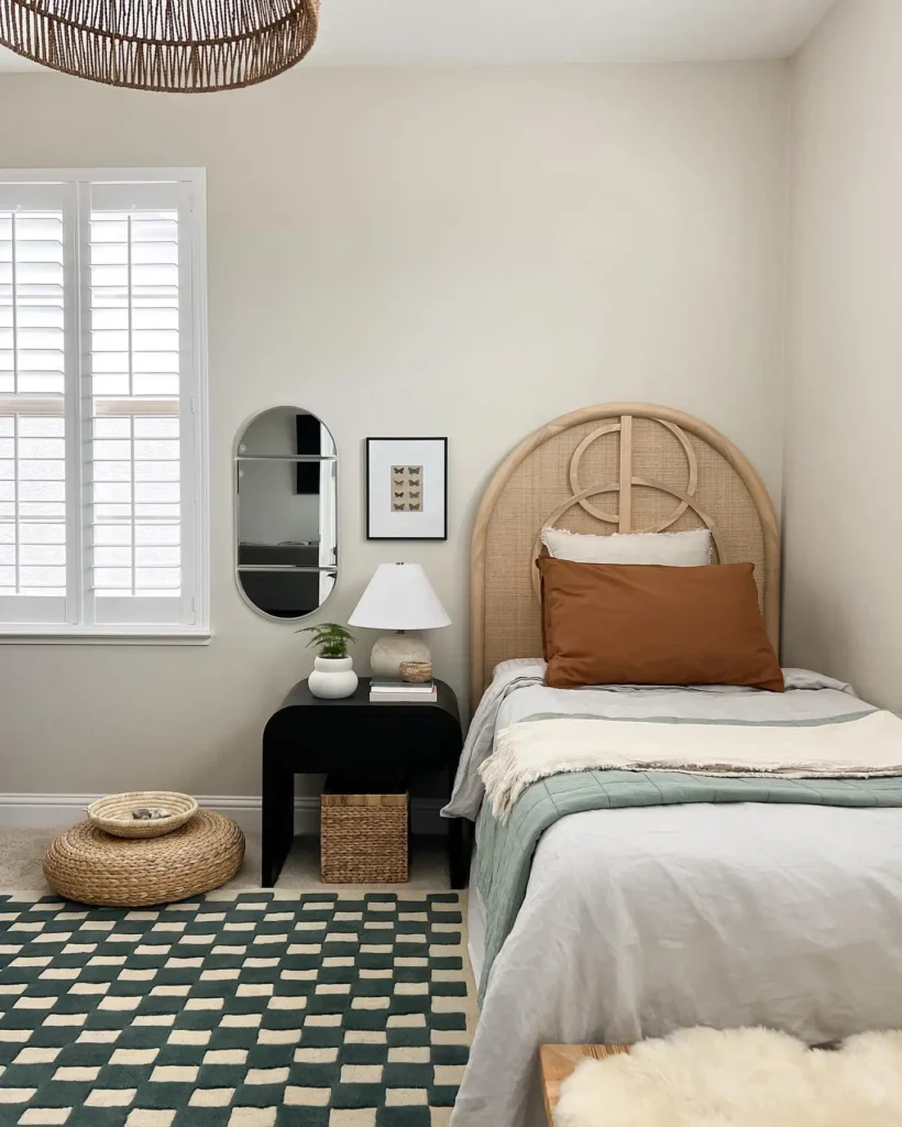 Preteen girls bedroom with rattan headboard, checkered rug, woven accents, and neutral tones.
