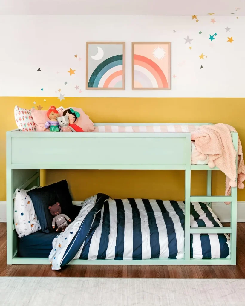 Boy and girl shared bedroom with bunk beds, rainbow wall art, and star decals.