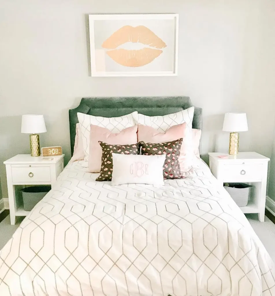 Preteen girls bedroom decorated with soft pink pillows, white bedding, gold accents, and chic wall art.
