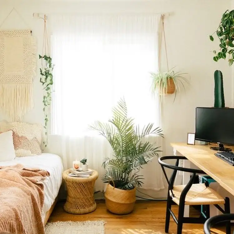 macramé wall art, wooden desk, hanging plants, and cozy natural decor.