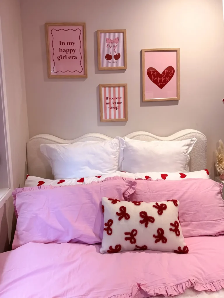 Preteen girls bedroom with pink bedding, heart-print pillows, framed wall art, and cozy decorative accents.
