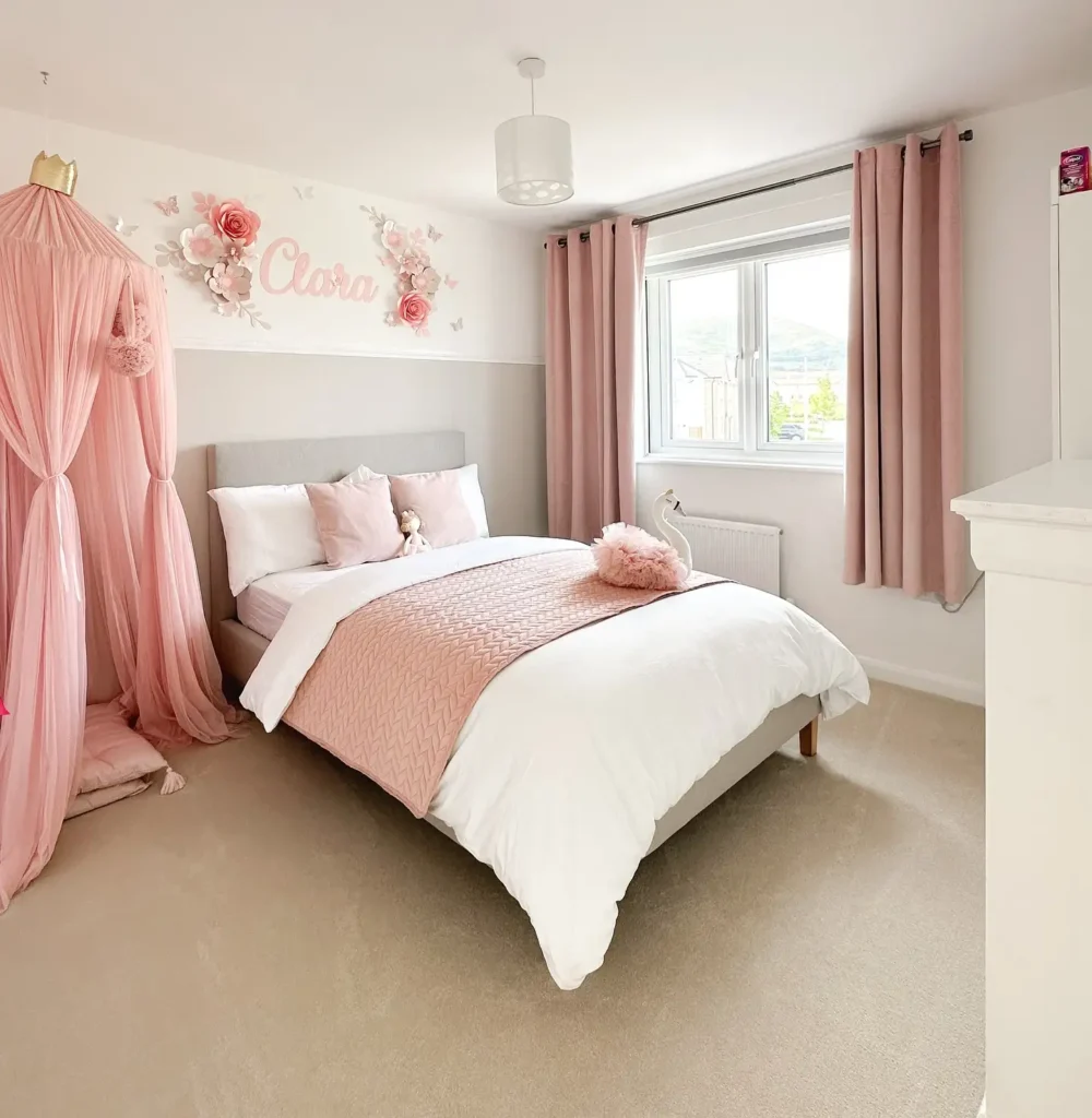 Preteen girls bedroom decorated with blush pink canopy, floral wall art, soft curtains, and elegant bedding.
