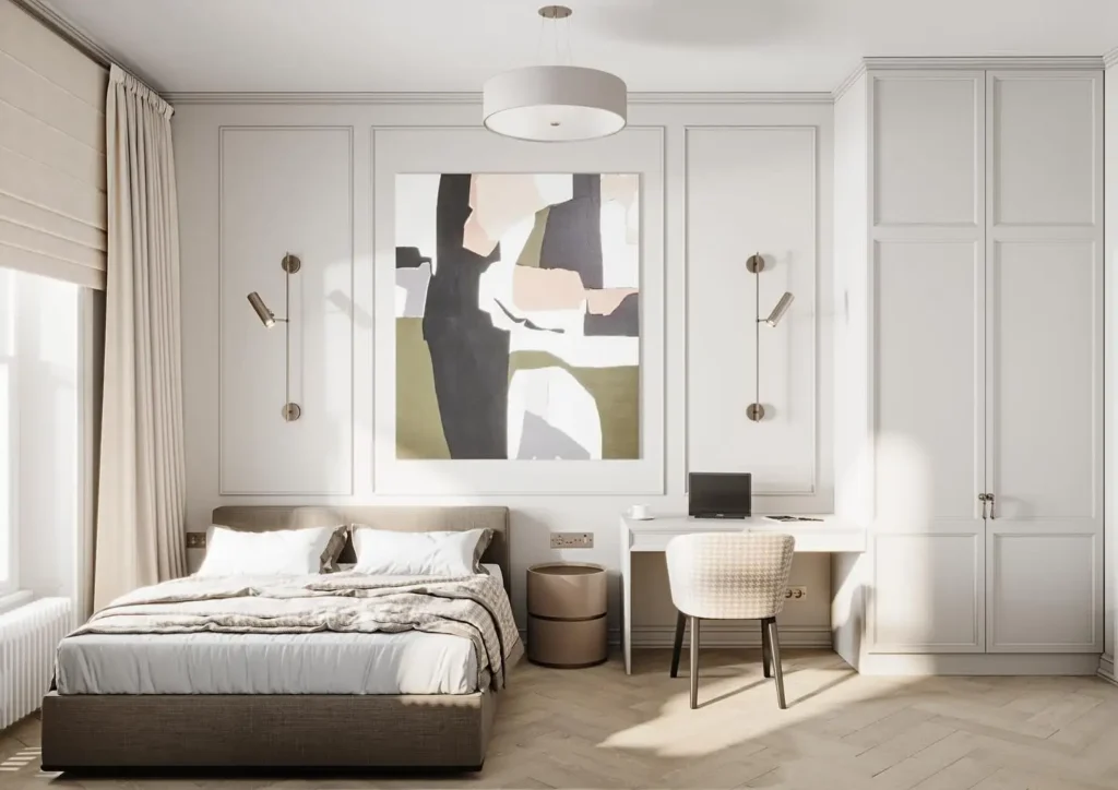 gray and white bedding, abstract wall art, brass lights, and a built-in desk with cabinetry.