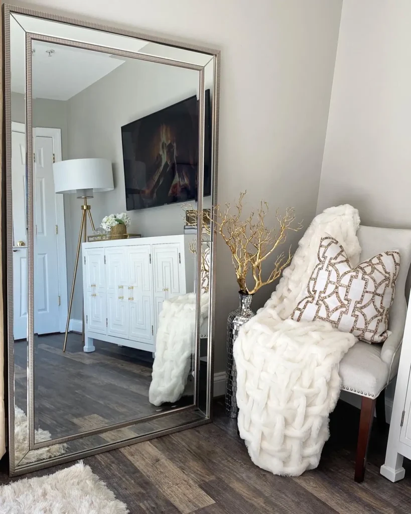 Glamorous full length mirror in bedroom with metallic frame, faux fur, and gold accents