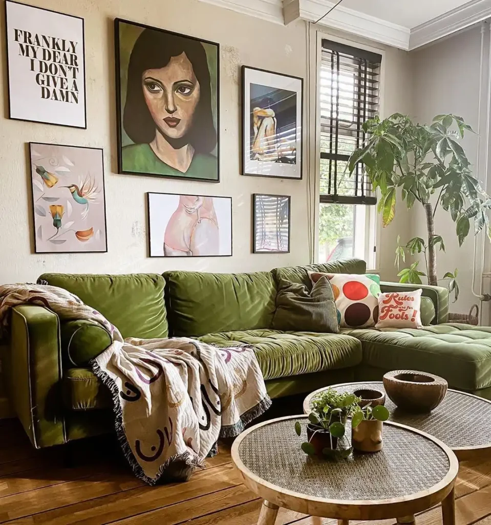 Living room with green velvet sofa, eclectic gallery wall, and cozy textiles showcasing creative wall decor ideas above couch.
