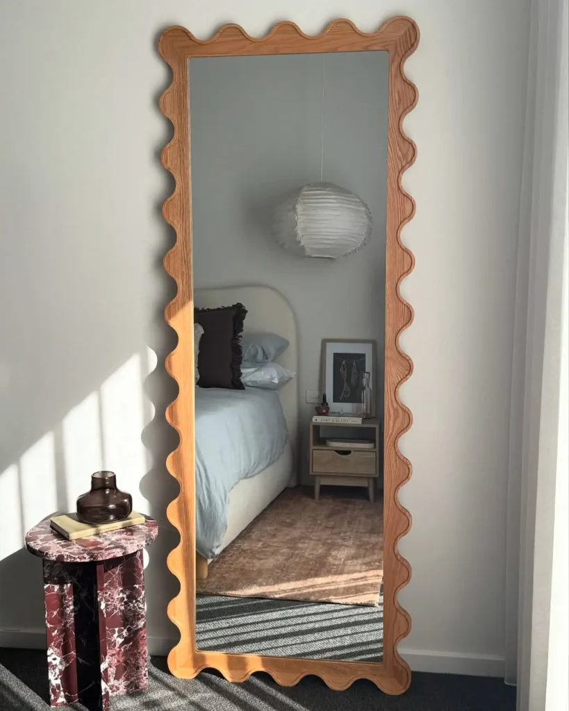 Contemporary full length mirror in bedroom with wavy wooden frame