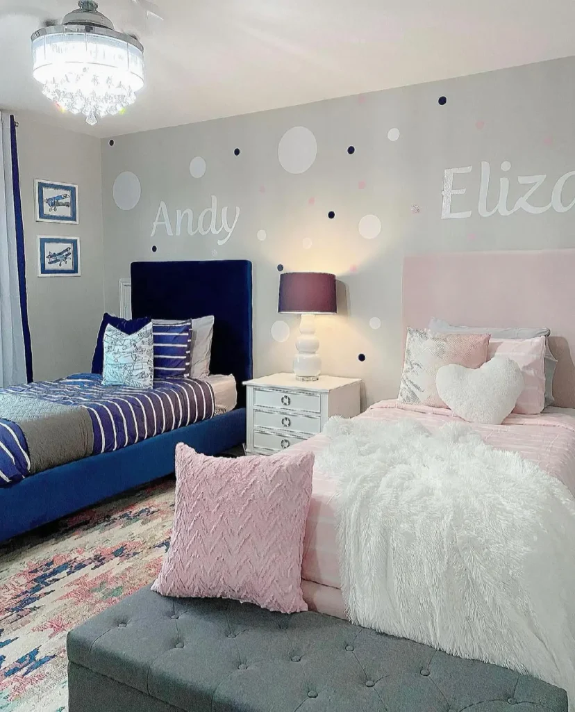 Boy and girl shared bedroom with names on wall décor, navy and blush bedding, and playful accents.
