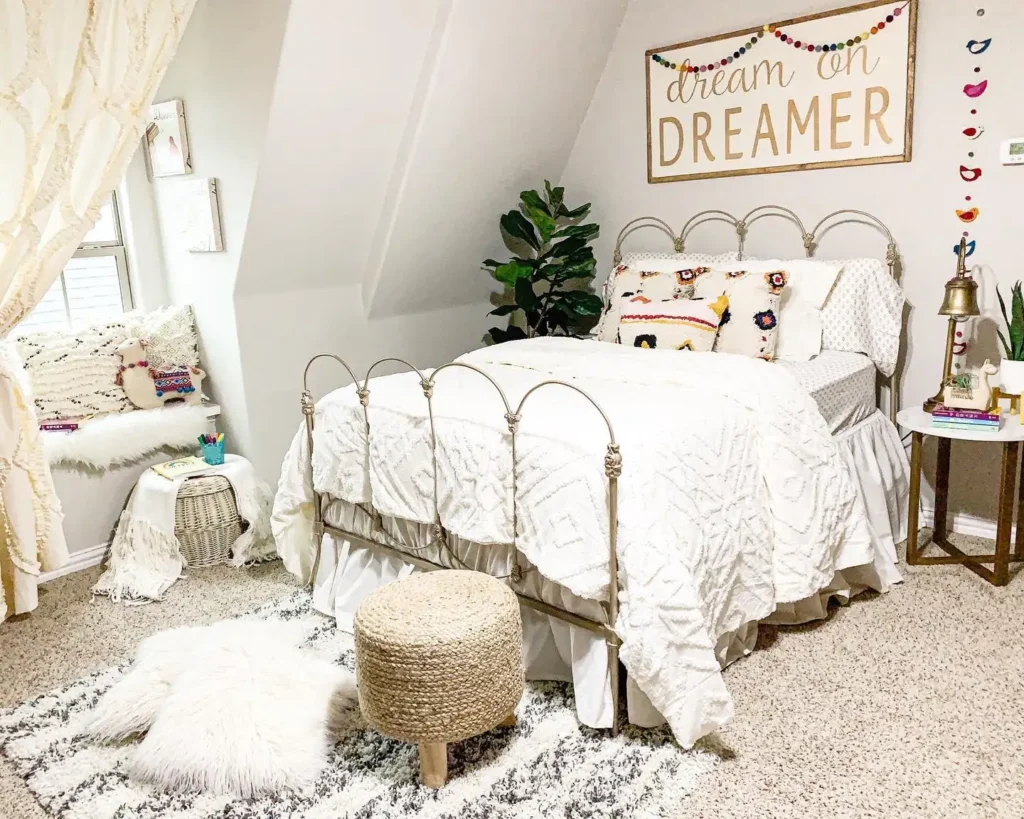 Preteen girls bedroom styled with boho bed frame, white bedding, colorful pillows, and cozy reading nook.
