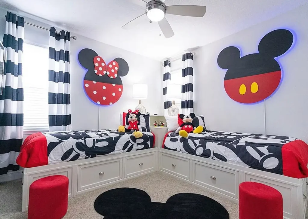 Boy and girl shared bedroom with Mickey and Minnie Mouse wall art and black, white, red décor.